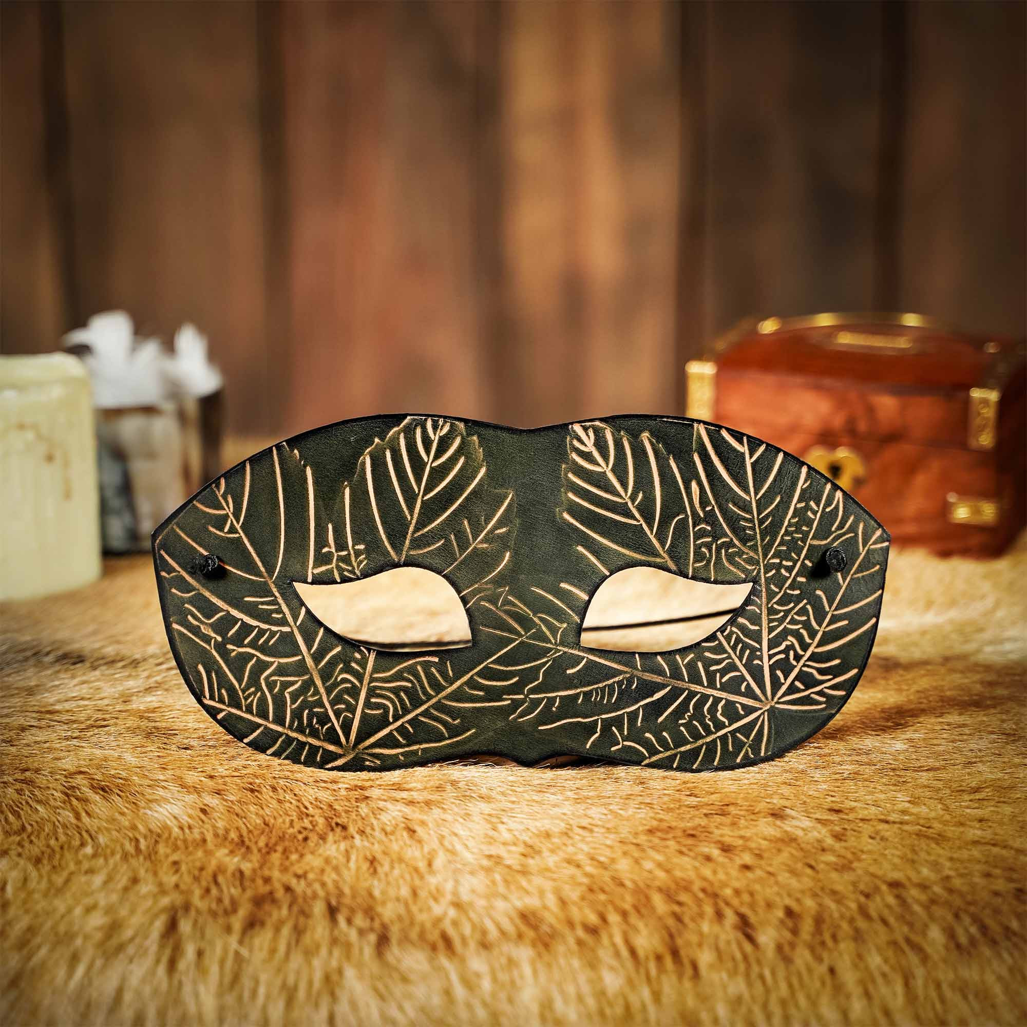 Green leather mask with embossed maple leaf motifs